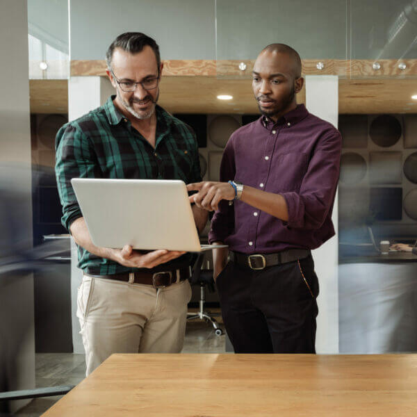 Two colleagues looking at laptop