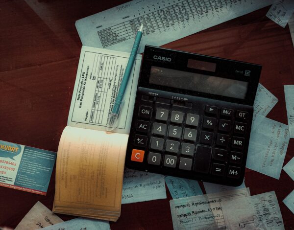 Paper invoice and Casio calculator