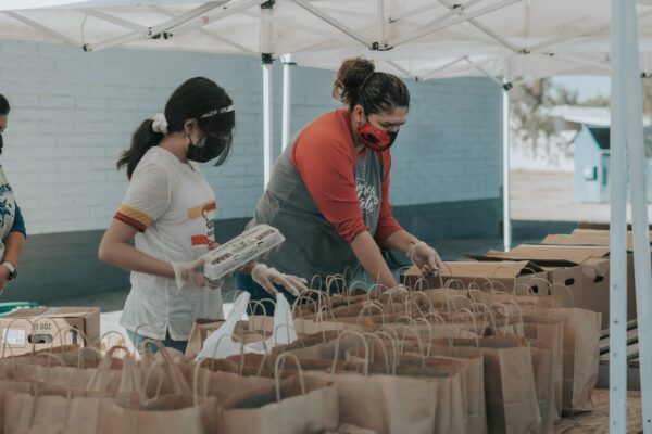 Two nonprofit workers setting up a food drive