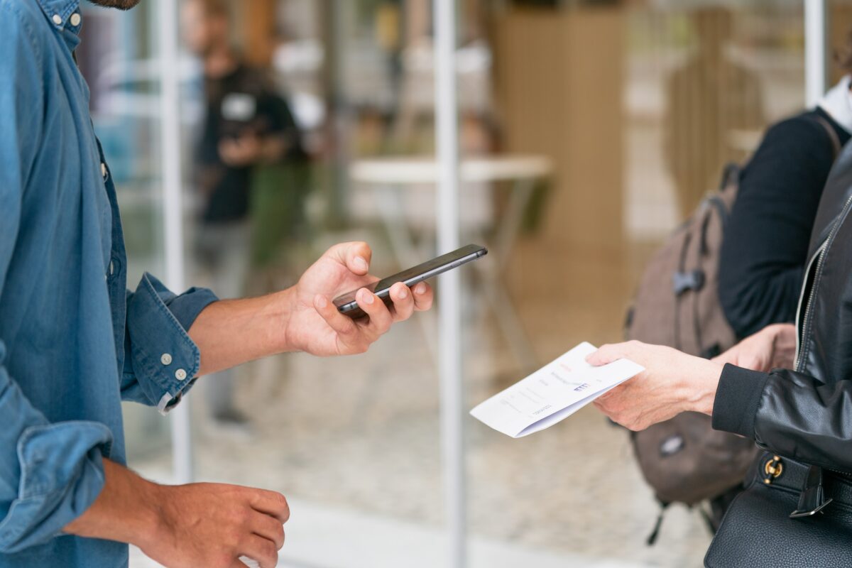 Man using OCR on mobile phone to capture receipt data