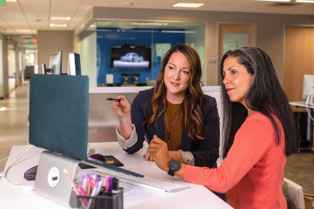 Two women working together on accounts payable with their Dynamics 365 setup.