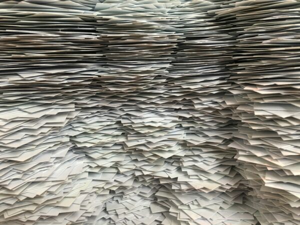 Stacks of paper checks waiting for the trash to switch to electronic payments