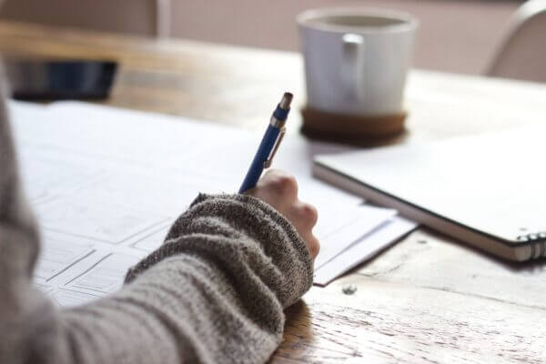 AP department worker writing on a paper check for payables