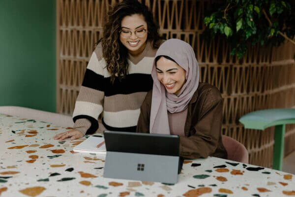 Two nonprofit colleagues looking at their Blackbaud CRM for data accuracy