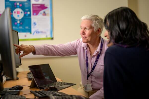 Two nonprofit colleagues working at a computer together