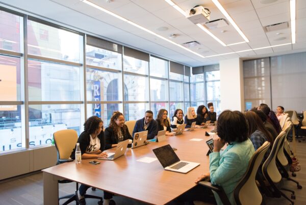 A nonprofit team sits around a conference table to collaborate in Blackbaud CRM