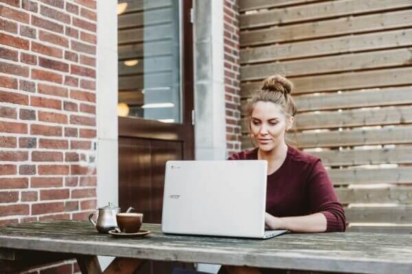 woman happily working outside making purchase orders within Dynamics GP ERP