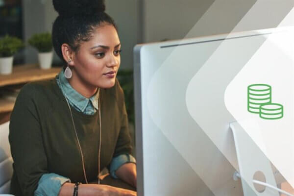 A woman works at a computer on her fundraising CRM technology