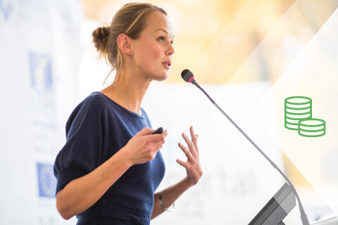Woman speaks at a podium for fundraising