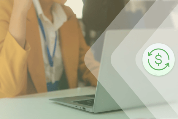 Woman using an open laptop with her healthcare name tag